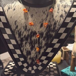 Liquid silver orange and red spiny lariat necklace.